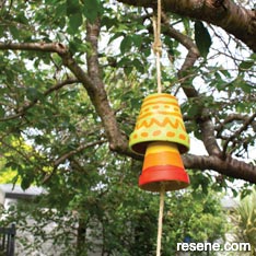 Paint terracotta pots to make a windchime for your garden