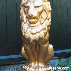 Paint a concrete statue in gold for your garden 