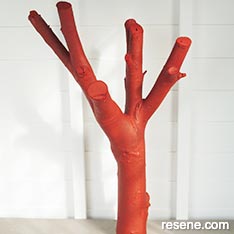 Paint a branch to make a garden sculpture