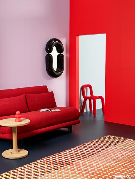 A serene interior painted in pastel pink and hot red