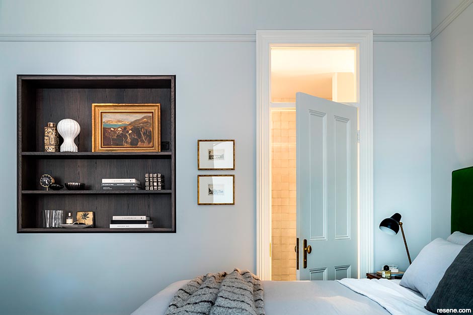 Elegant wall cavity shelving features in this bedroom