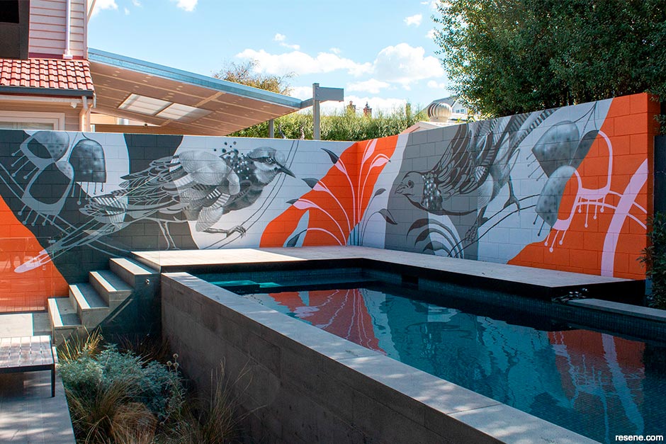 A poolside mural with lively splashes of colour